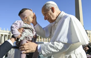 Pope Leo XIV blesses a baby in St. Peter’s Square during his general audience on Wednesday, Nov. 5, 2025, at the Vatican. Credit: Vatican Media