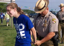 A Maryland state trooper handcuffs Joan Walsh, 18.?w=200&h=150