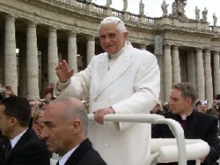 Pope Benedict rides through St. Peter's Square in the popemobile.