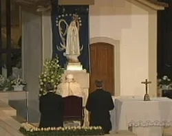 Pope Benedict prays at the candle light vigil.?w=200&h=150