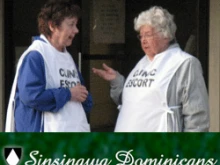 Sister Donna Quinn and standing with another abortion clinic escort (L to R)