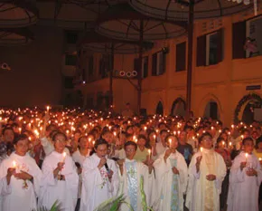 Priests and parishioners hold a candle light vigil by Lake Ba Giang?w=200&h=150