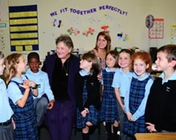 Mrs. Barbara Henkels poses for a picture with Catholic school children?w=200&h=150