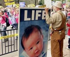 A pro-life protestor holding a protest sign?w=200&h=150