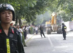 Vietnamese police stand guard as bulldozers work to demolish nunciature?w=200&h=150