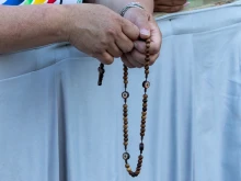 A pilgrim prays the rosary at a Marian vigil in St. Peter’s Square, Rome, Saturday, Oct. 11, 2025.