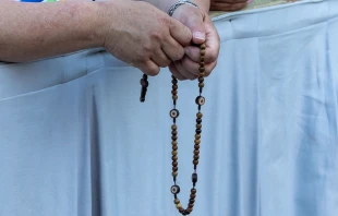 A pilgrim prays the rosary at a Marian vigil in St. Peter’s Square, Rome, Saturday, Oct. 11, 2025. Credit: Daniel Ibáñez/CNA