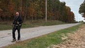 Father Gary Graf walks down a rural road during his trek across America in support of immigrants on Friday, Oct. 17, 2025.