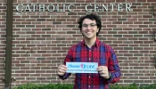 Gabriel Dionisi, a 22-year-old college student who makes pro-life bumper stickers with the goal of spreading the pro-life message and spread awareness to others, displays one of his works.