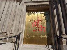 Vandalism on a door of the Cathedral Basilica of the Immaculate Conception in Denver, Colo., Oct. 10, 2021.