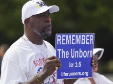 A man holds a sign at a pro-life rally in front of the Lincoln Memorial on June 24, 2023, marking the first anniversary of the U.S. Supreme Court's Dobbs decision overturning Roe v. Wade.