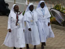 Three religious sisters attend Mass for the martyrs of Uganda on Nov. 28. 