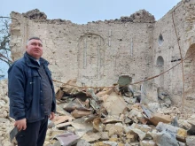Father Oleksandr Repin among the church ruins