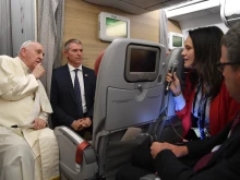 Pope Francis speaking with journalists on the papal plane on July 30.