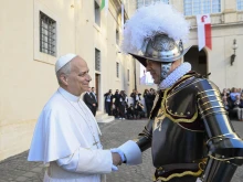 Pope Leo XIV greets a member of the Swiss Guard during a swearing-in ceremony at the Vatican, Saturday, Oct. 4, 2025.