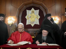 Pope Leo XIV and Ecumenical Patriarch Bartholomew I of Constantinople sign a joint declaration at the Palace of the Ecumenical Orthodox Patriarchate in Istanbul, Turkey, on Nov. 29, 2025.