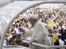 Pope Francis greets the crowd in Bahrain's national soccer stadium before offering Mass on Nov. 5, 2022.