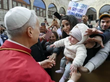 Pope Leo XIV greets a young mother and her child outside of the Monastery of St. Maron in Annaya, Lebanon, on Dec. 1, 2025.