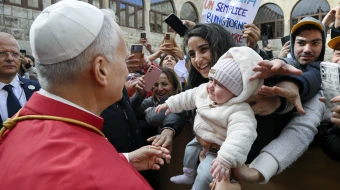 Pope Leo XIV greets a young mother and her child outside of the Monastery of St. Maron in Annaya, Lebanon, on Dec. 1, 2025.