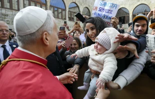 Pope Leo XIV greets a young mother and her child outside of the Monastery of St. Maron in Annaya, Lebanon, on Dec. 1, 2025. Credit: Vatican Media