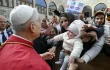 Pope Leo XIV greets a young mother and her child outside of the Monastery of St. Maron in Annaya, Lebanon, on Dec. 1, 2025.