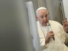 Pope Francis speaks to the media on Feb. 5, 2023, during his return flight to Rome from his visit to the Democratic Republic of Congo and South Sudan.