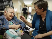 Melanie McClanahan, a Rosary Team volunteer, with a resident.