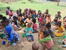 Schoolchildren in Tigray, Ethiopia, eat biscuits and tea provided by Mary's Meals.
