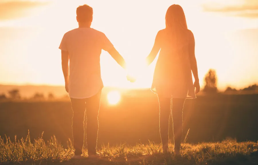 Couple holding hands at sunset. ?w=200&h=150