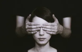 Eyes covered by hands /   Ryoji Iwata on Unsplash