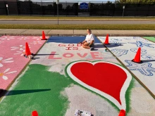 Sabrina Steffans displays her newly decorated school parking space.