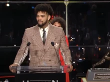 Caleb Williams, a graduate of Gonzaga College High School in Washington, D.C., accepts the Heisman Trophy.