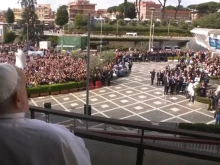 Pope Francis looks out at the crowd gathered below his hospital window at Rome's Gemelli Hospital on March 23, 2025.