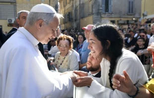 Pope Leo XIV greets a young woman along the streets of Albano, Italy, before offering Mass in the Cathedral Basilica of St. Pancras near Castel Gandolfo on July 20, 2025. Credit: Vatican Media