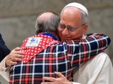 Pope Leo XIV hugs a man during the Jubilee of Roma, Sinti, and Travelers on Saturday, Oct. 18, 2025.