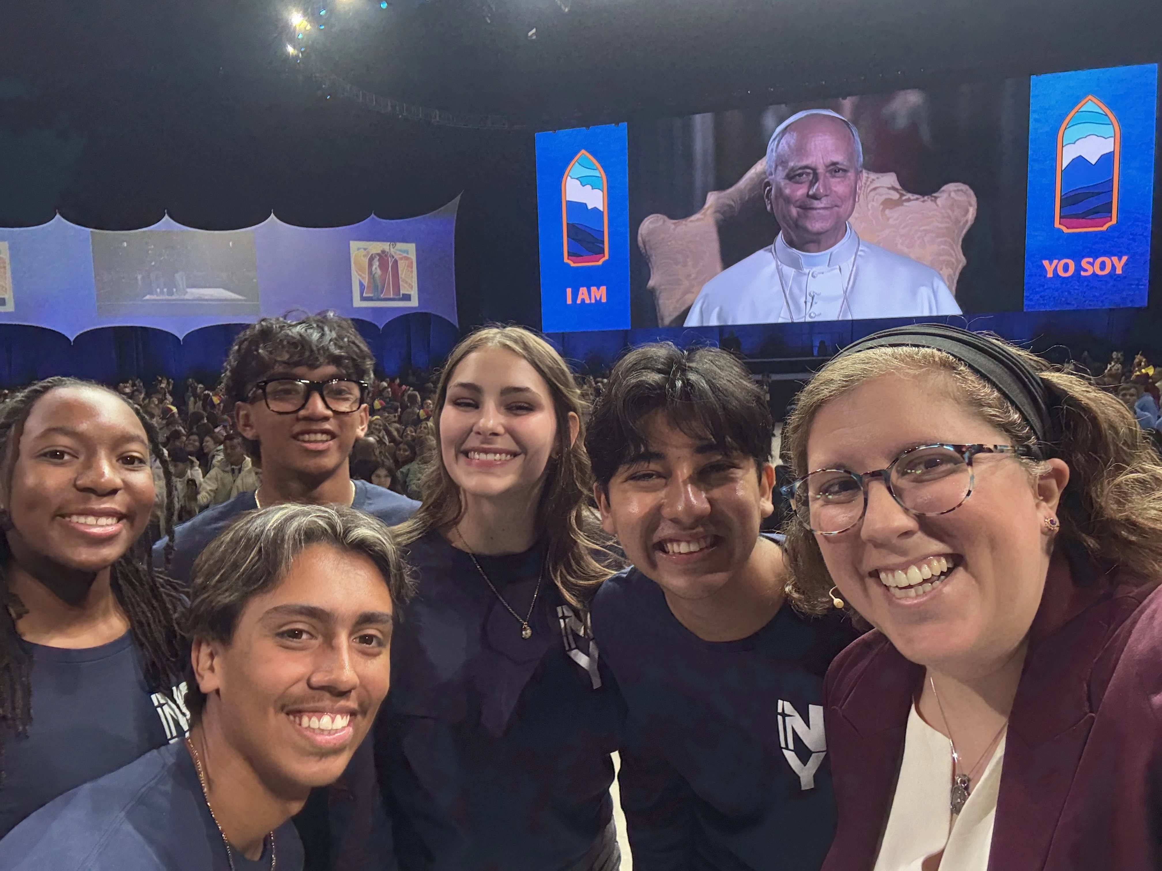 Teens Mia Smothers, Ezequiel Ponce, Micah Alcisto, Elise Wing, and Chris Pantelakis, and moderator Katie McGrady, right, speak with Pope Leo XIV during a live digital encounter at Lucas Oil Stadium on Nov. 21, 2025. | Credit: Courtesy of Katie McGrady