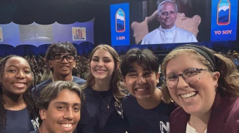 Teens Mia Smothers, Ezequiel Ponce, Micah Alcisto, Elise Wing, and Chris Pantelakis, and moderator Katie McGrady, right, take a “selfie” with Pope Leo XIV during a live digital encounter at Lucas Oil Stadium on Nov. 21, 2025.