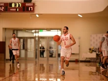 Ricky Reyes dribbles the ball up court as now-Father Peter Schirripa follows behind at the national basketball tournament for seminaries in 2022.