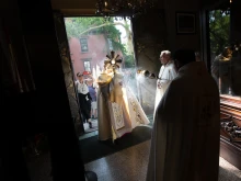 Bishop Robert J. Brennan of Brooklyn holds the Eucharist as he enters Our Lady of Lebanon Maronite Cathedral in Brooklyn, New York, on May 26, 2024. The visit was part of the New York leg of the National Eucharistic Pilgrimage.