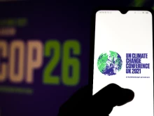 The 2021 UN Climate Change Conference (COP26) logo displayed on a smartphone.