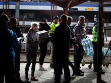 Polish volunteers help Ukrainian refugees arriving at a train station in Przemyśl, southeastern Poland.