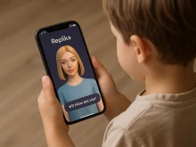 A child holds a phone with the Replika app open and an image of an AI companion. Apps that promise to help recreate digital versions of deceased family members using AI pose a “spiritual danger” to Catholics and others who may use the technology in place of healthy grief, experts say.
