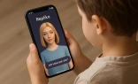 A child holds a phone with the Replika app open and an image of an AI companion. Apps that promise to help recreate digital versions of deceased family members using AI pose a “spiritual danger” to Catholics and others who may use the technology in place of healthy grief, experts say.