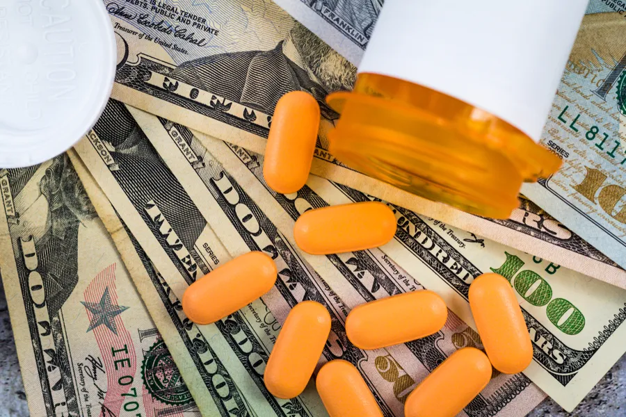 Prescription medicine on dollar bills. Via Shutterstock?w=200&h=150