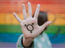 Woman with transgender symbol on her hand. 