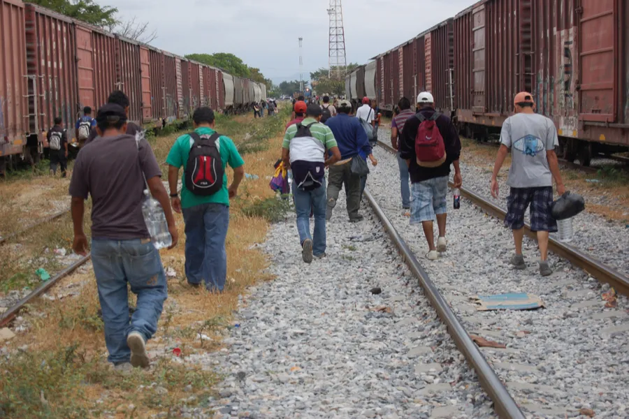 Central American migrants and asylum seekers prepare to board a freight train in Oaxaca, Mexico.?w=200&h=150