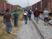Central American migrants and asylum seekers prepare to board a freight train in Oaxaca, Mexico.
