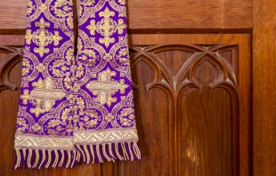 Purple stole and confessional. Roman023_photography/Shutterstock.