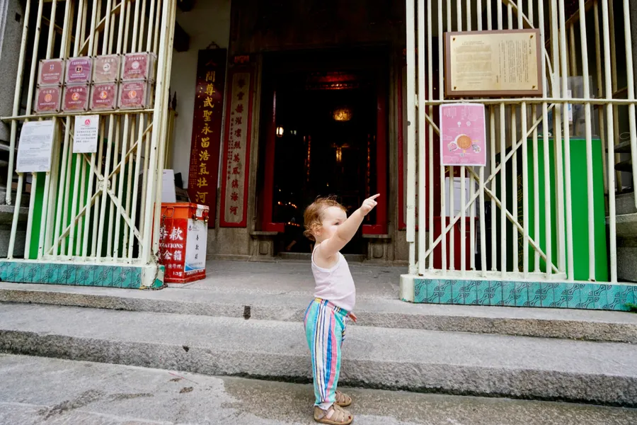 A child standing at the entrance of a house in central Hong Kong. ?w=200&h=150