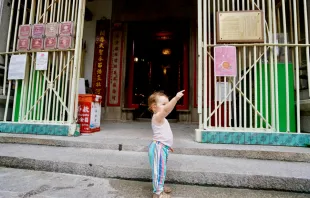 A child standing at the entrance of a house in central Hong Kong.   Wang Sing_Shutterstock